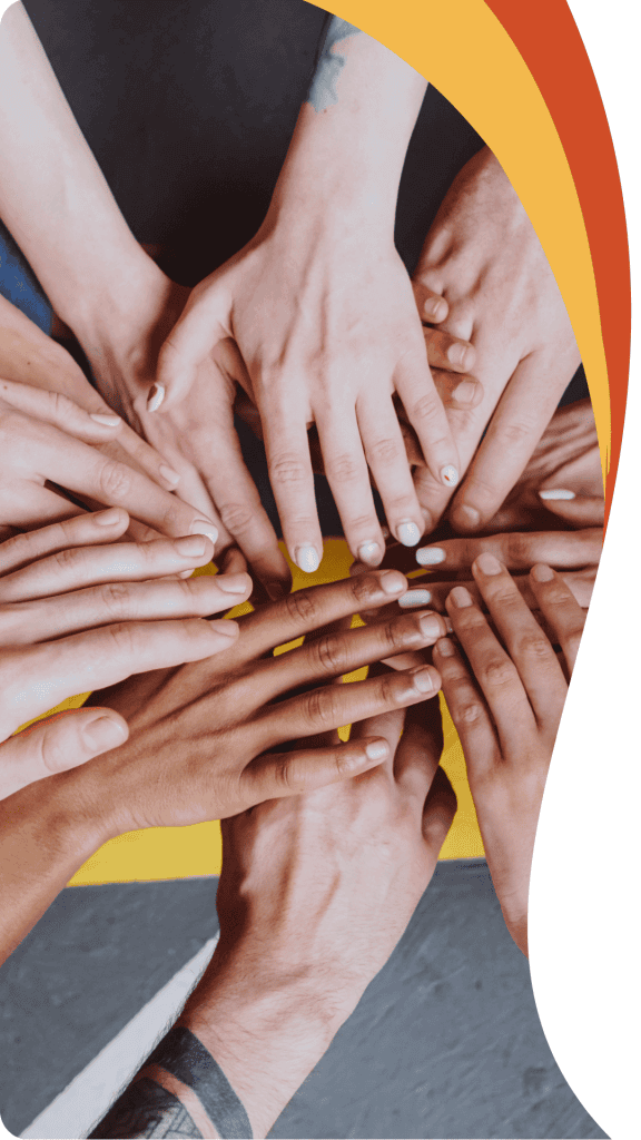 A diverse group of hands stacked together in a circle, representing the collaborative spirit of the Orlando mortgage team.