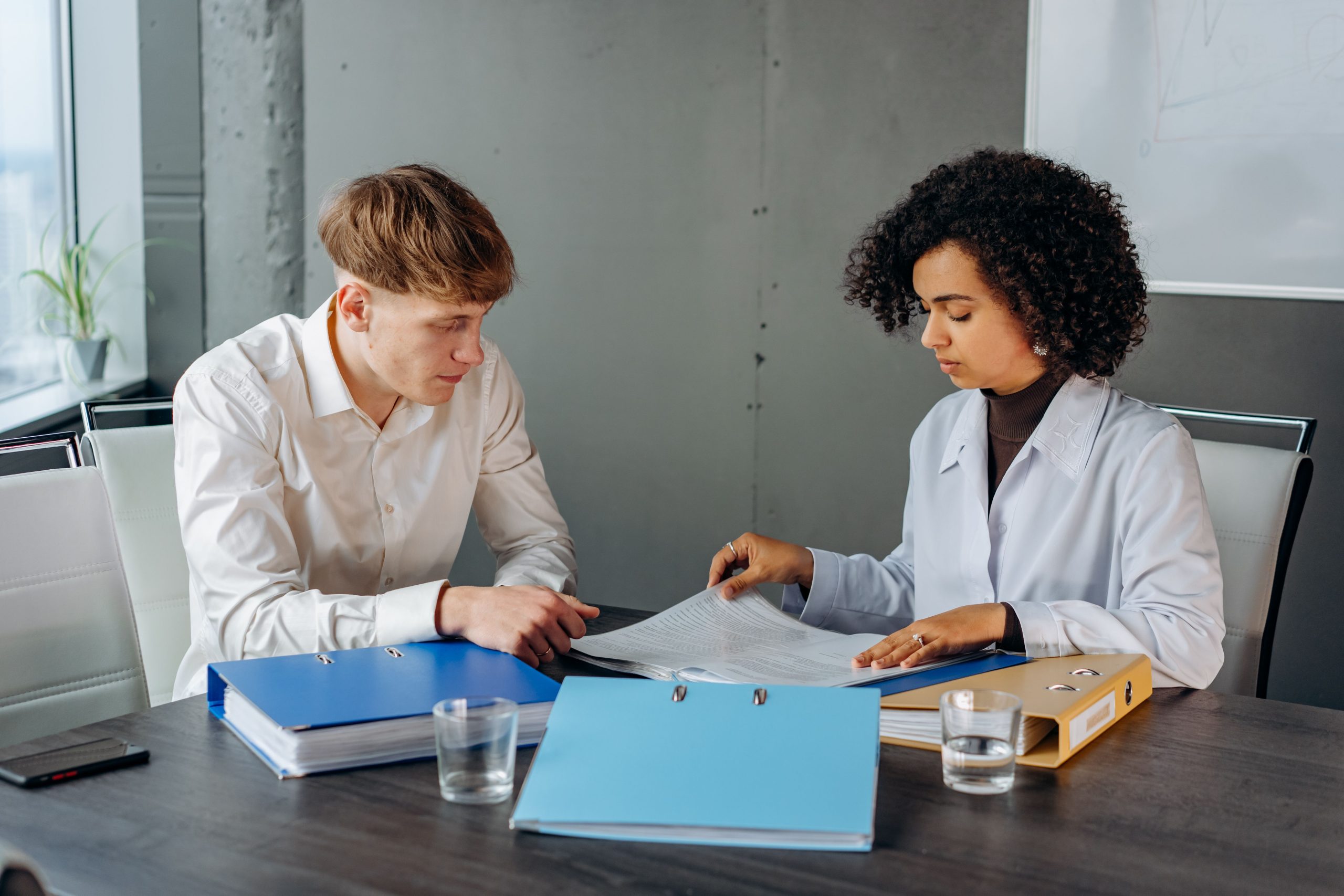 Two people reviewing paperwork at a desk